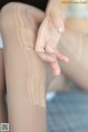 A close up of a woman's legs with a pair of stockings.